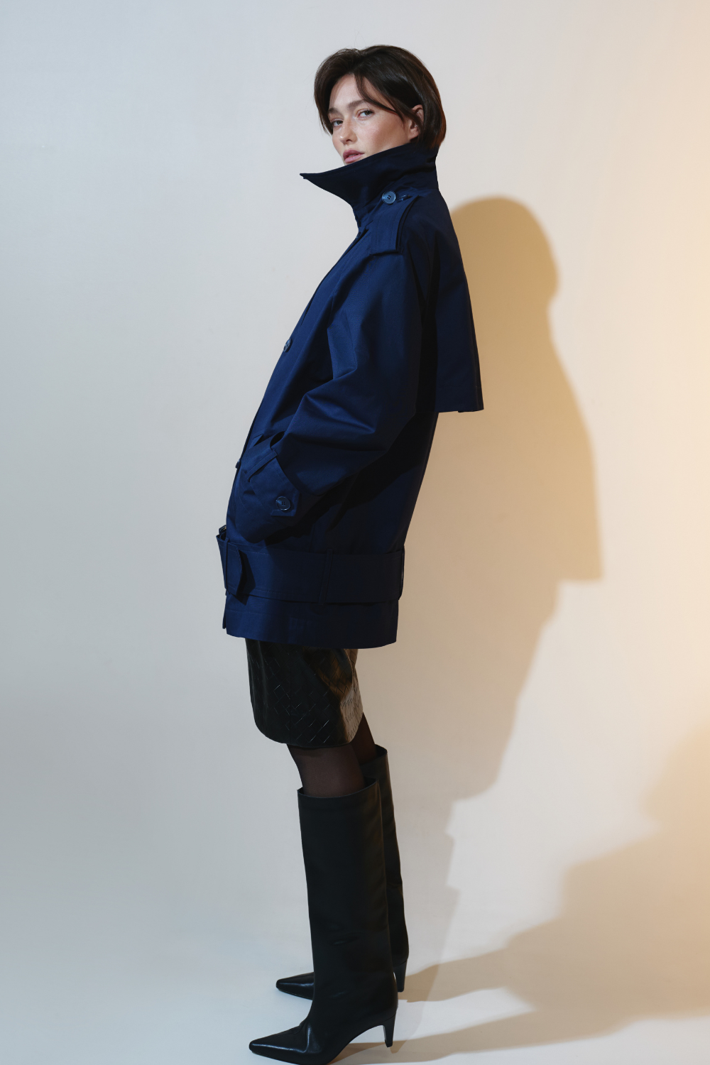 Deep blue trench coat with an accent on the low waist