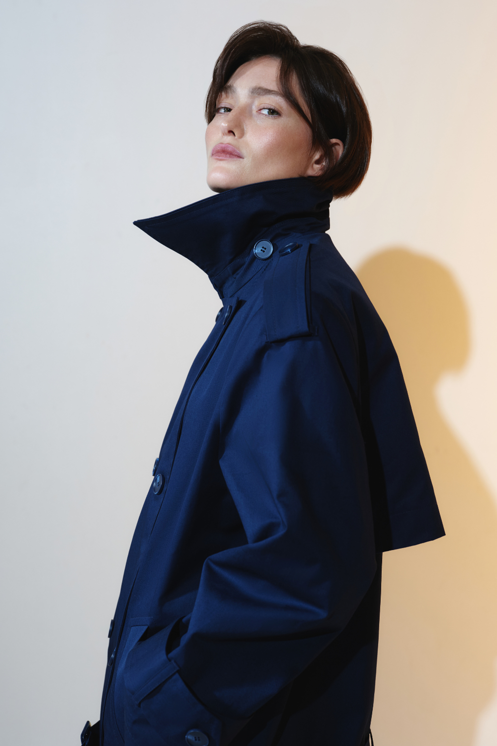 Deep blue trench coat with an accent on the low waist