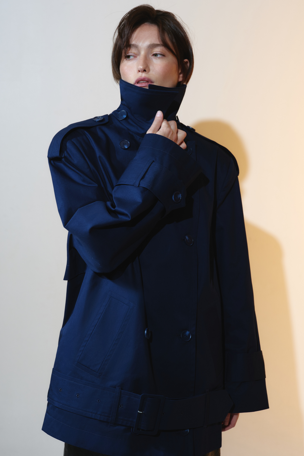 Deep blue trench coat with an accent on the low waist
